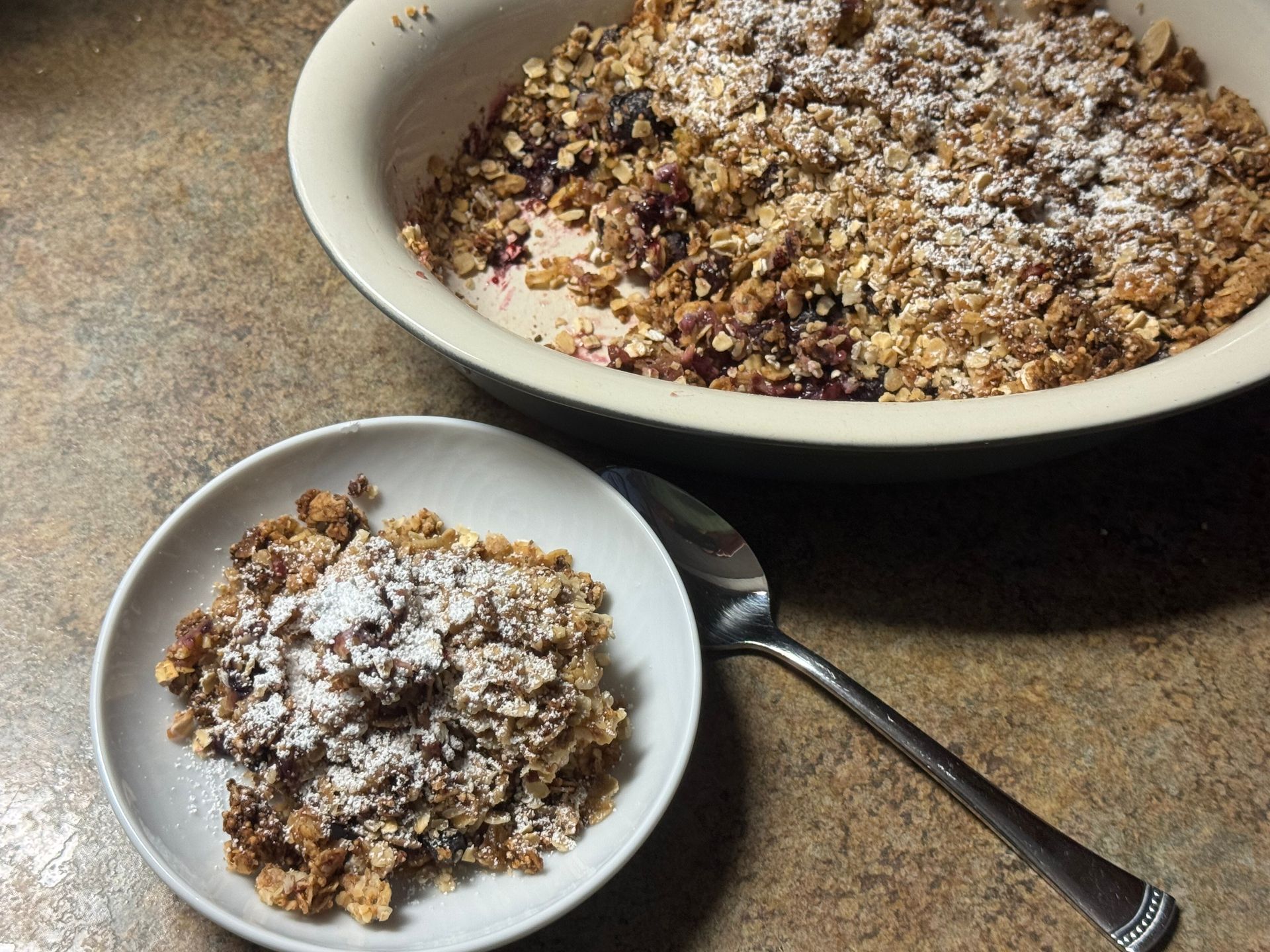 Three desserts are sitting on a table with a measuring cup in the background.