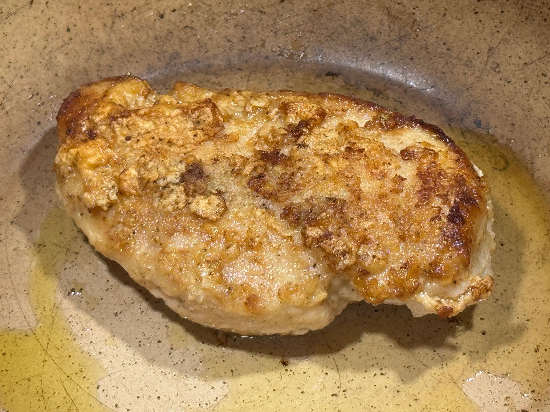 A person is rolling a burrito on a cutting board.
