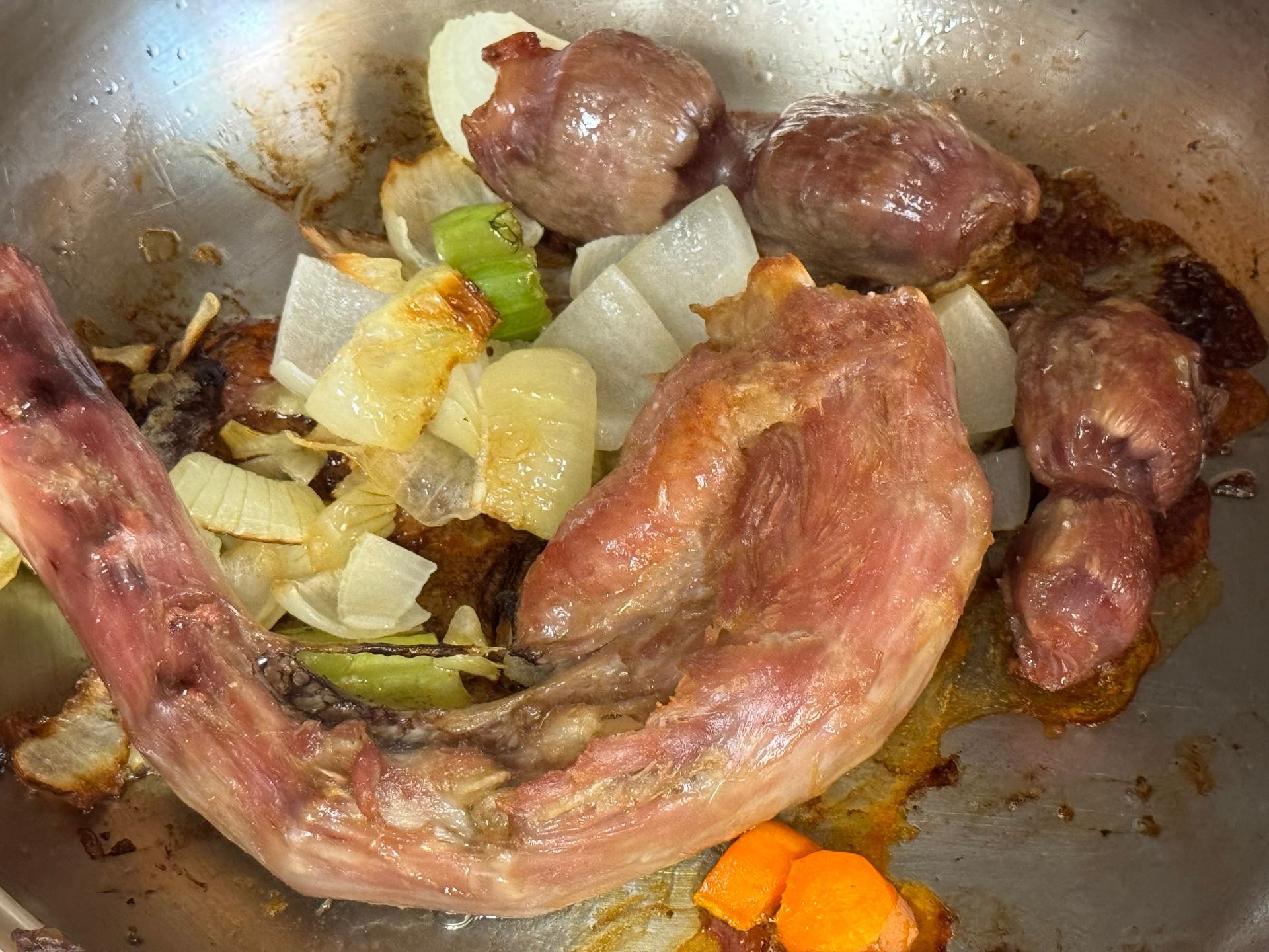 A close up of a pan filled with meat and vegetables.