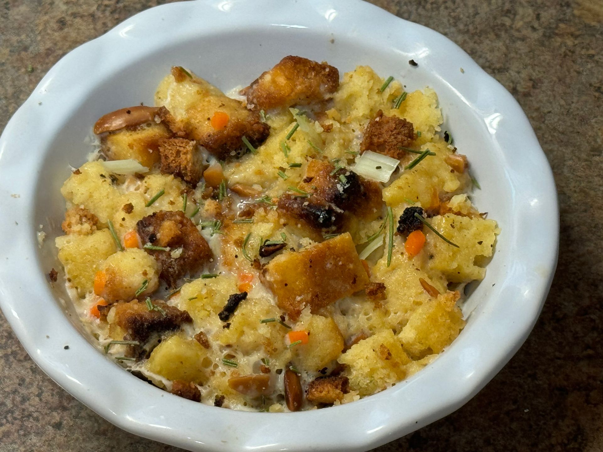 A bowl of stuffing is sitting on a table