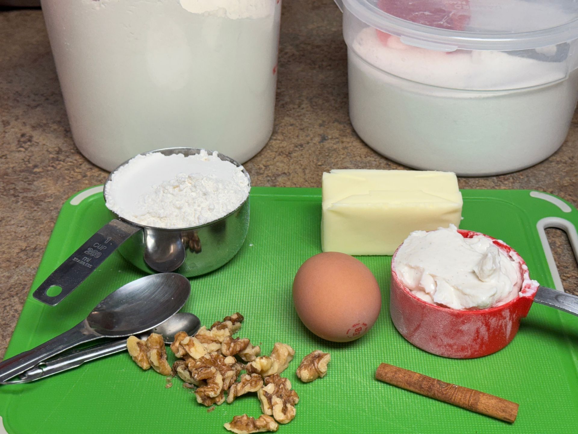 A green cutting board with a bunch of ingredients on it