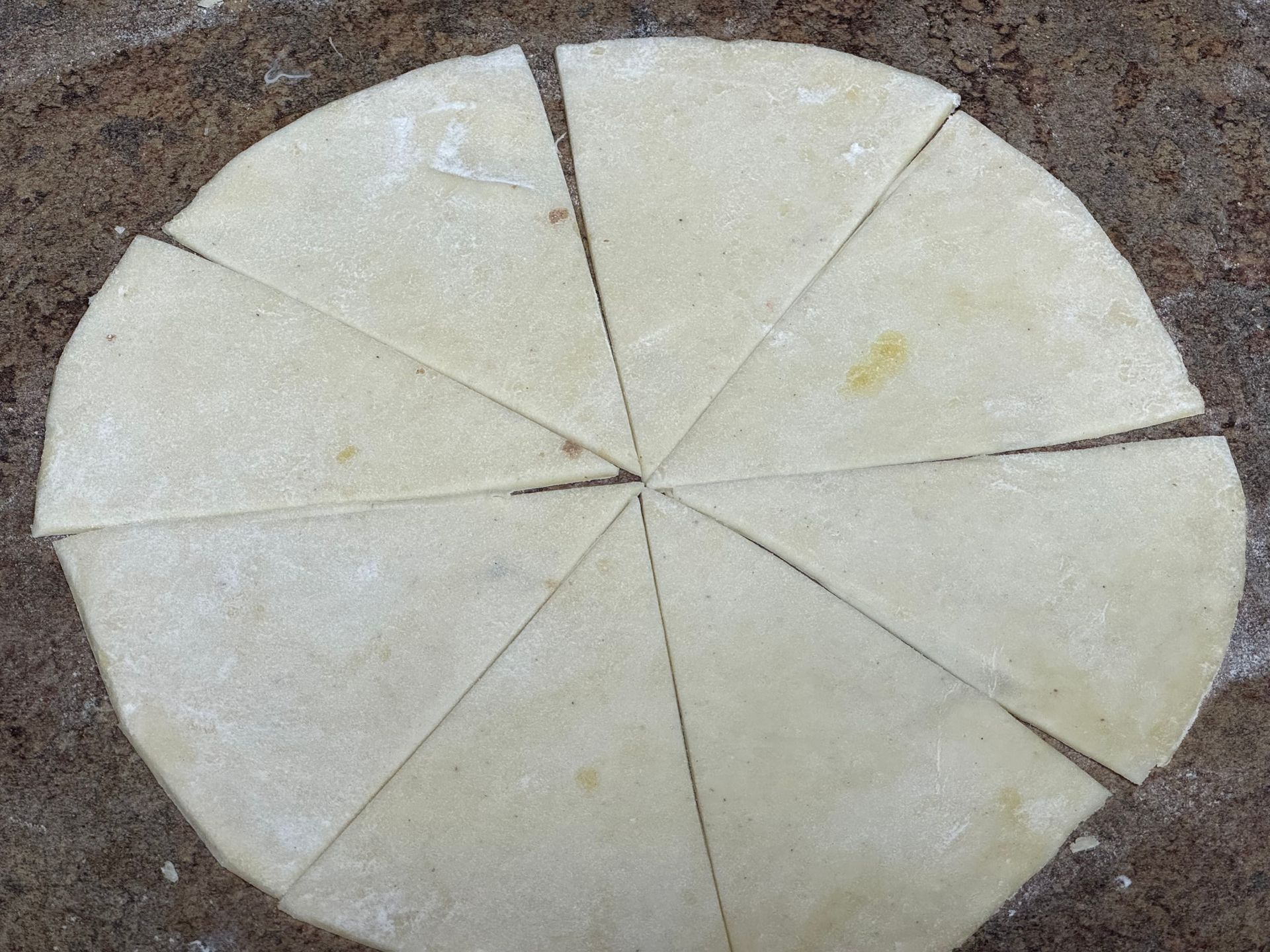 A circle of dough that has been cut into triangles
