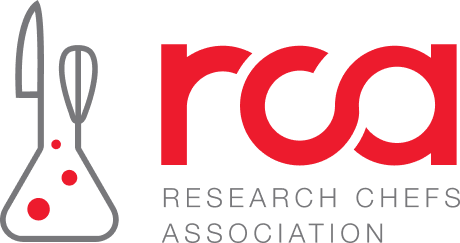 A logo for the research chefs association with a beaker and a whisk.