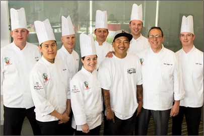 A group of chefs are posing for a picture together