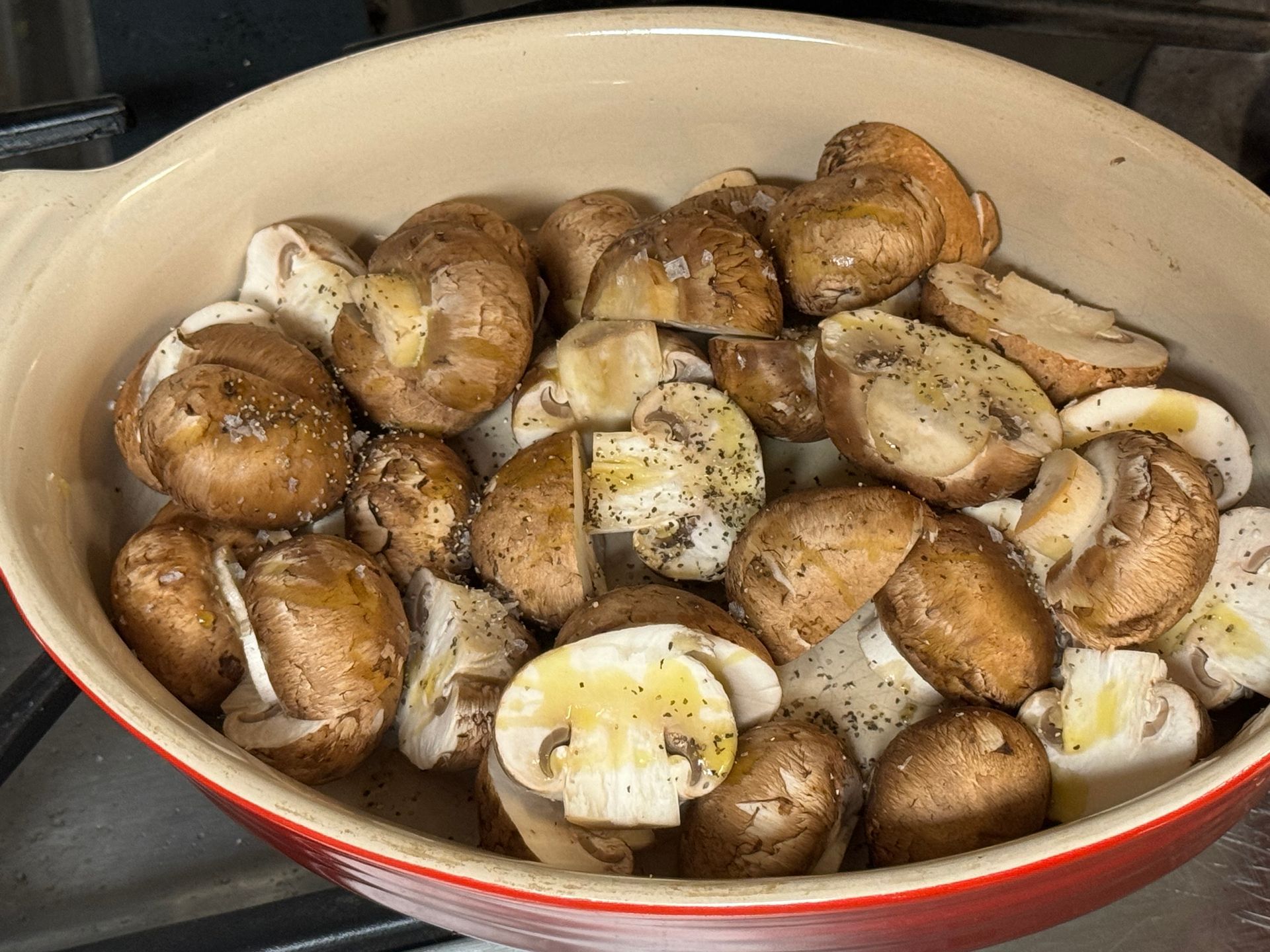 A bowl of mushrooms is sitting on a table.