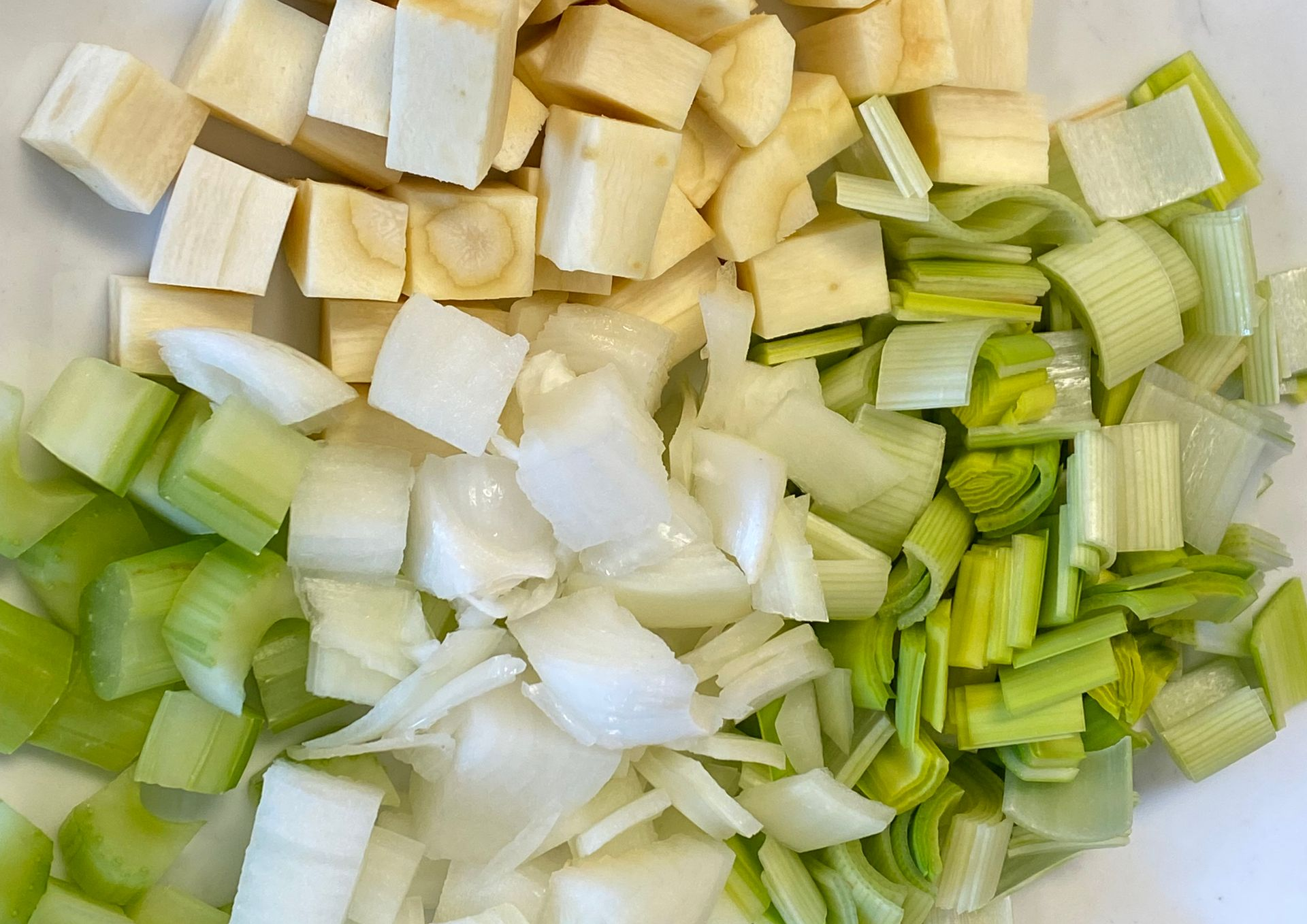 A pan filled with clams , onions , celery , and other ingredients.