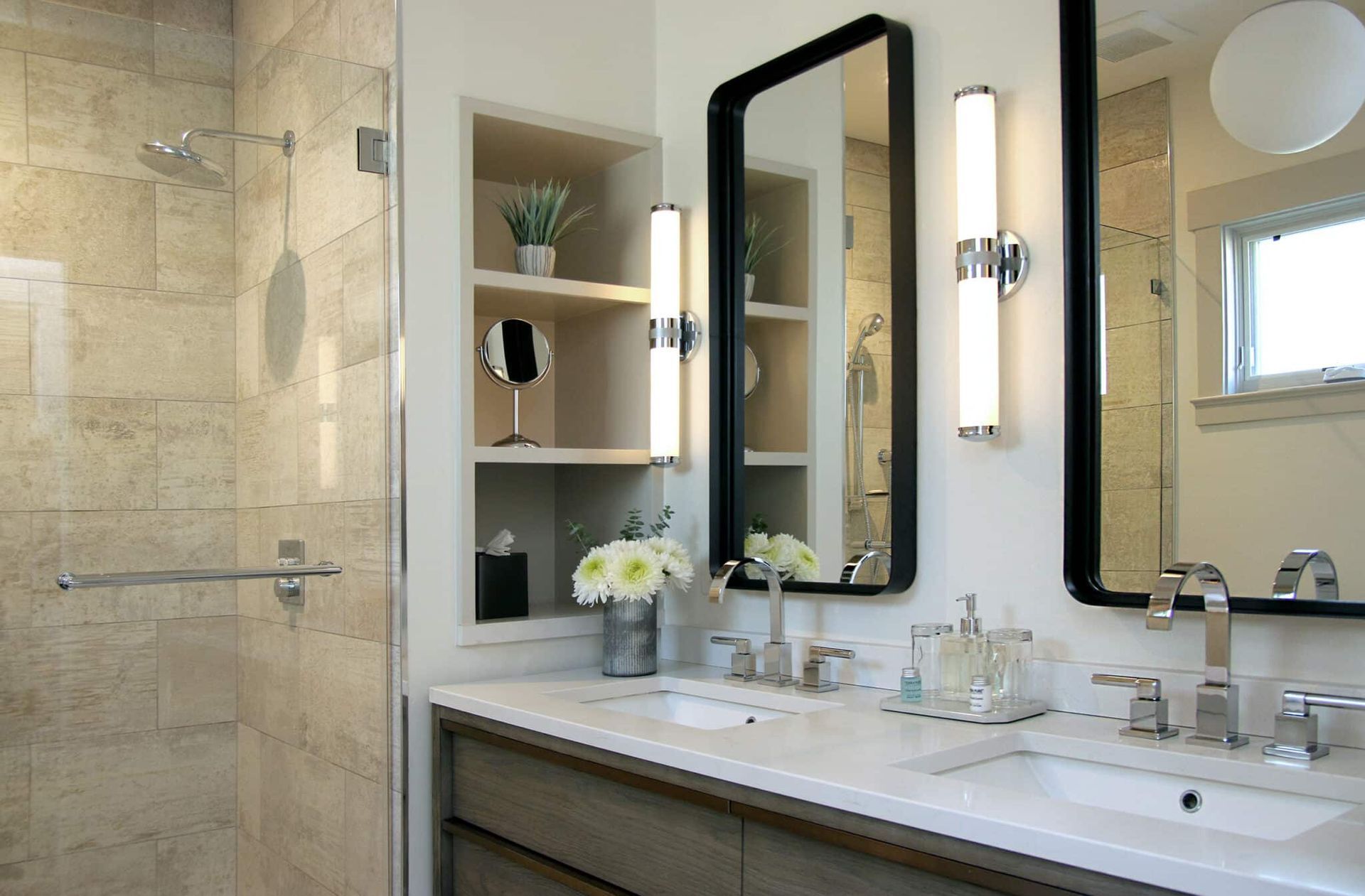 A bathroom with two sinks and two mirrors