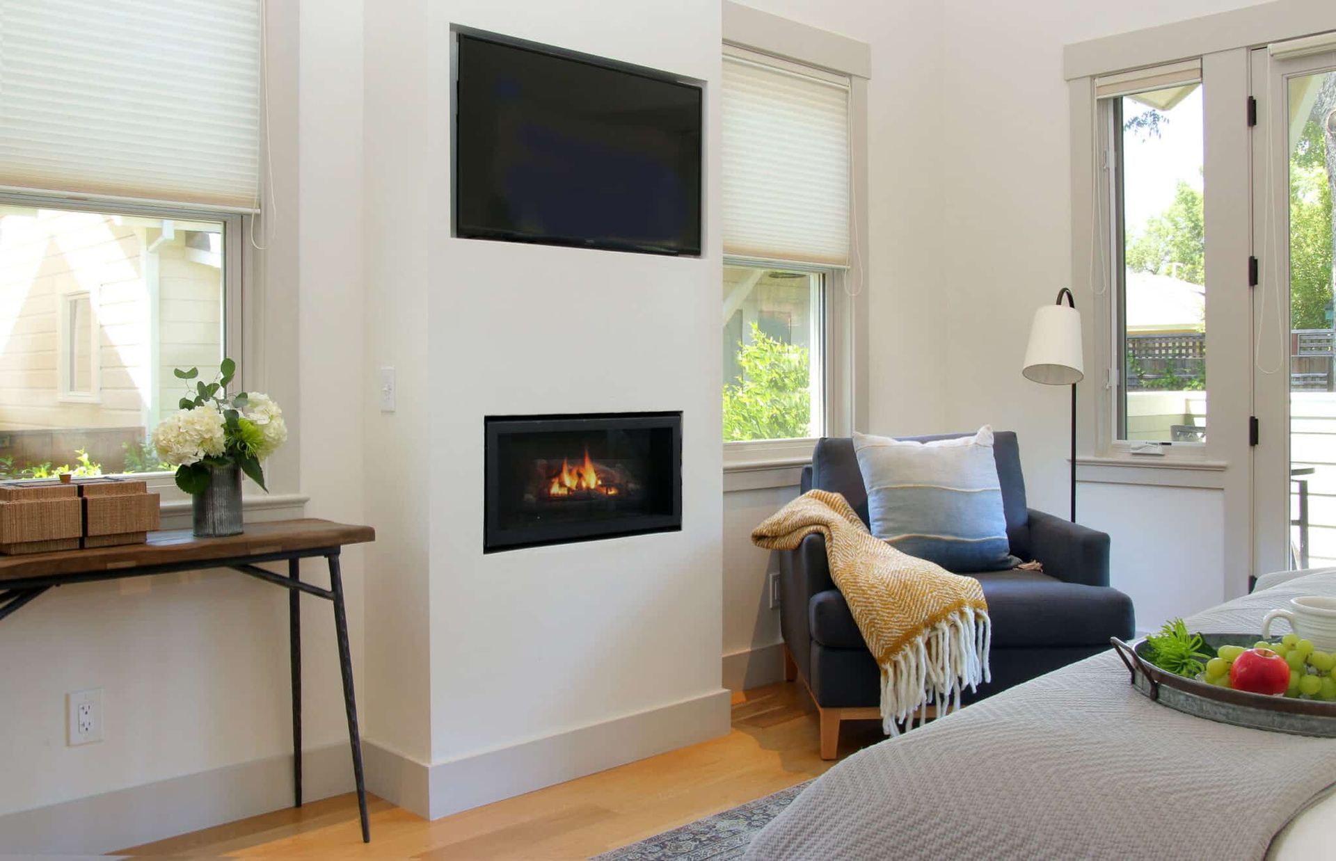 A living room with a fireplace and a flat screen tv.