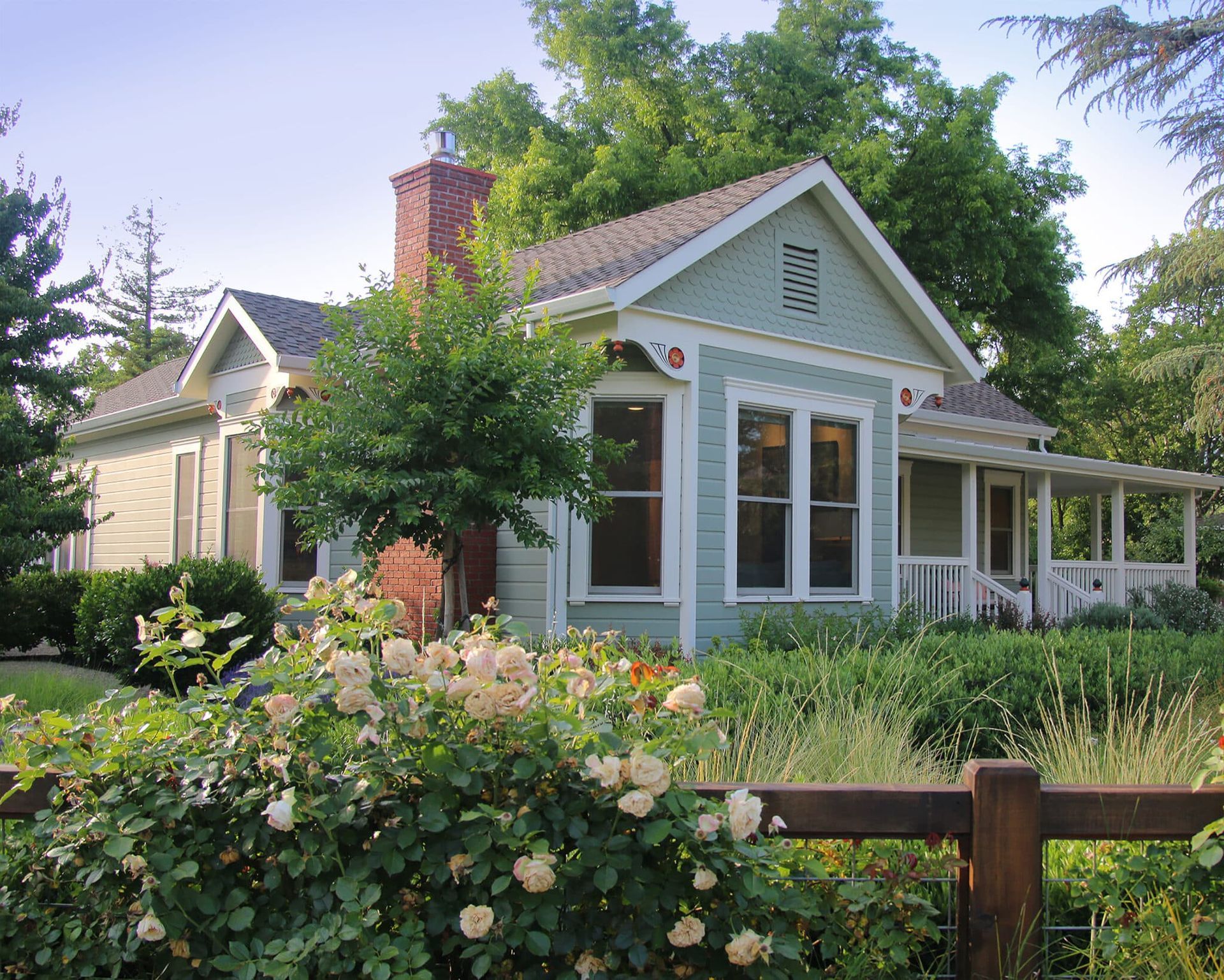 A small house with a wooden fence in front of it