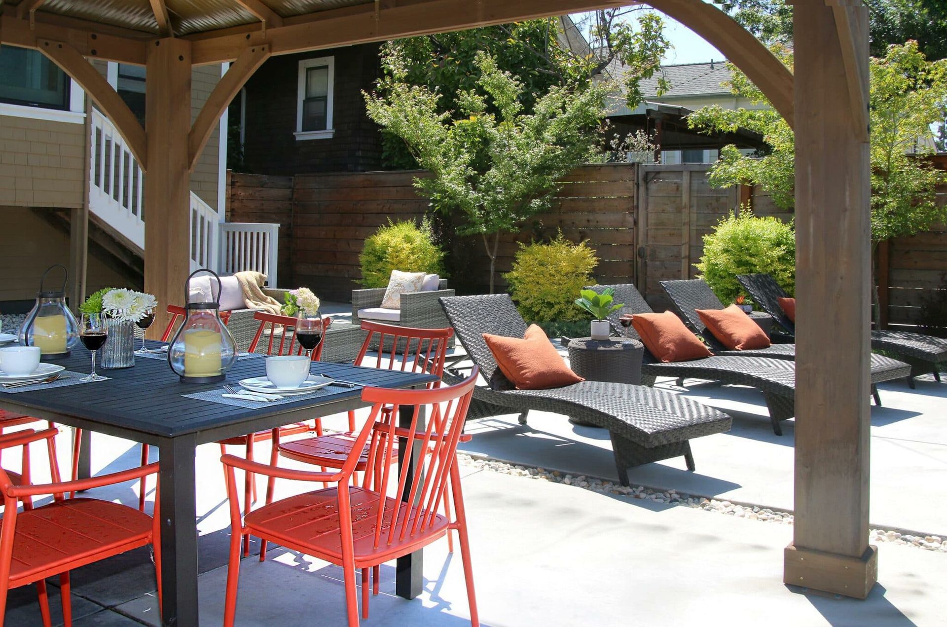 A patio with a table and chairs under a gazebo