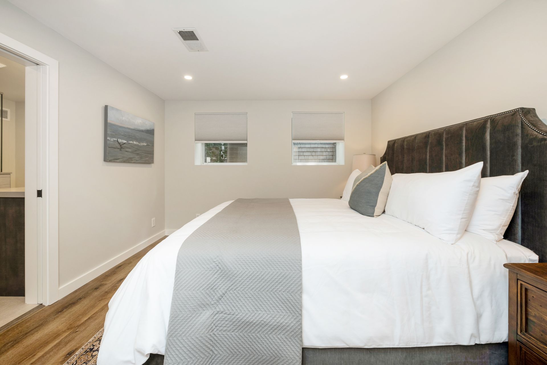 A bedroom with a king size bed and a nightstand.