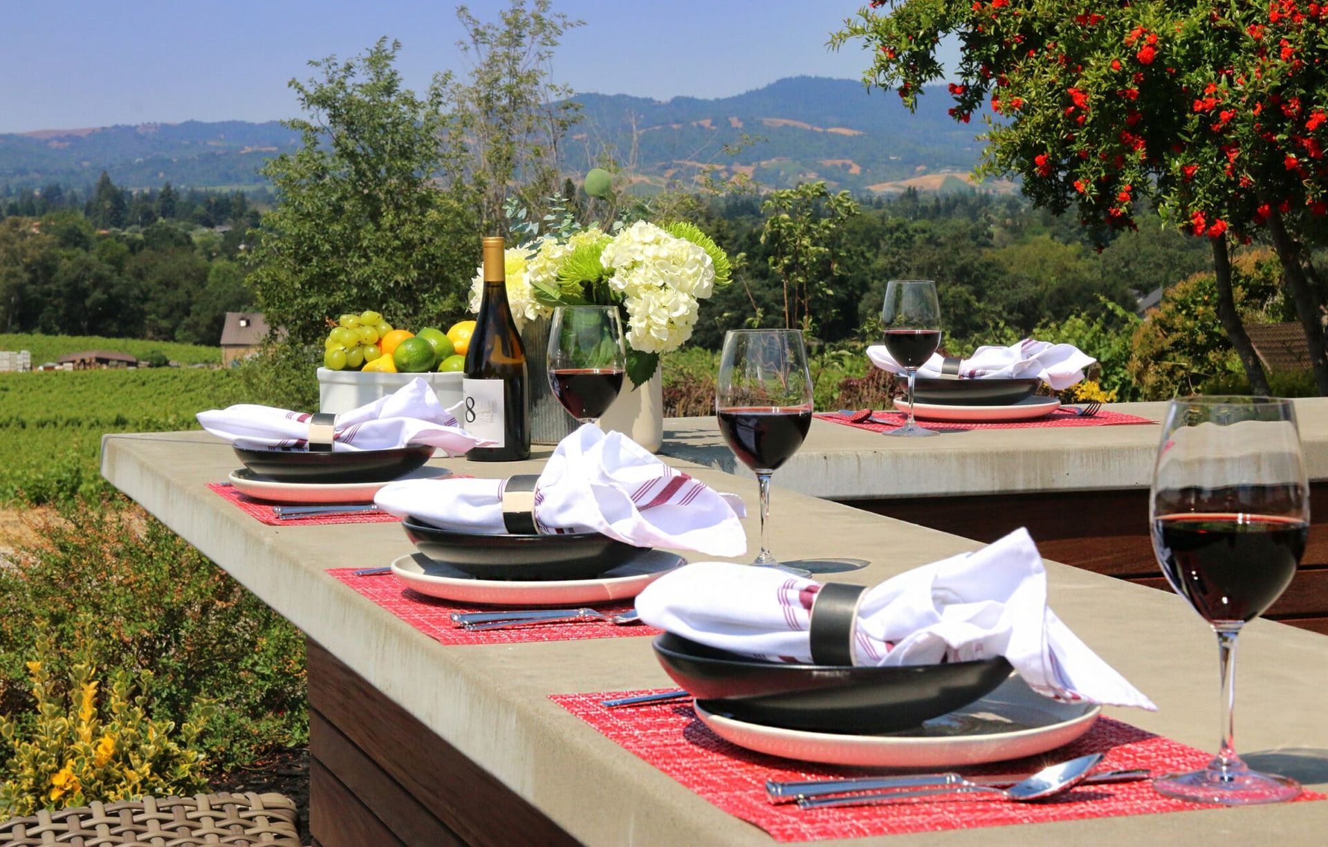 A table with plates and glasses of wine on it