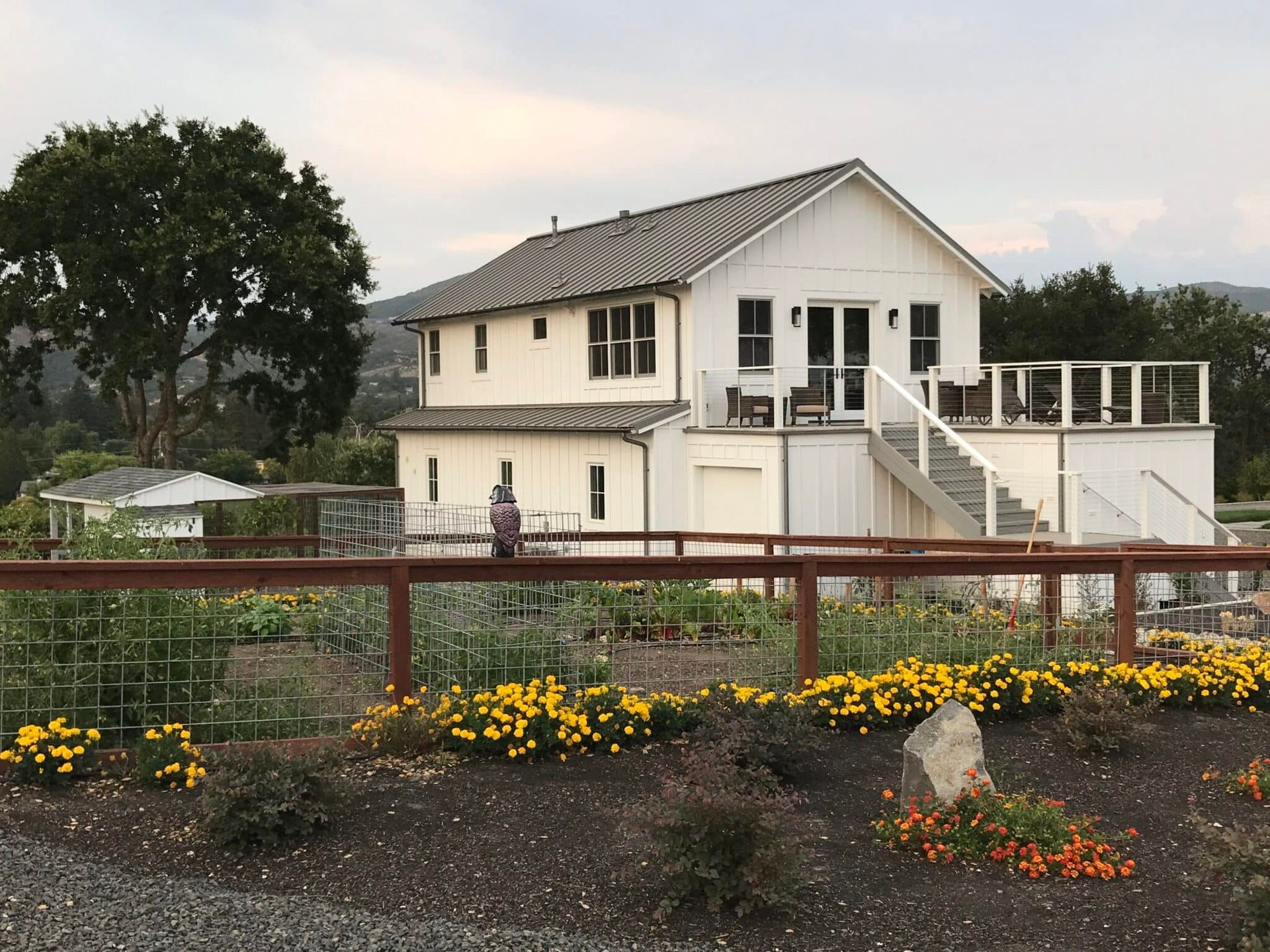A white house with a wooden fence in front of it