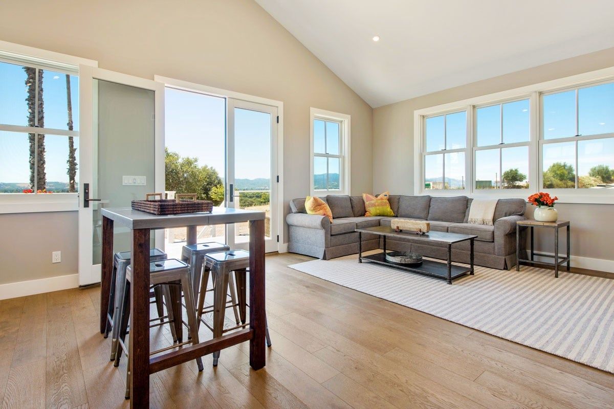 A living room with a couch , table , chairs and stools.