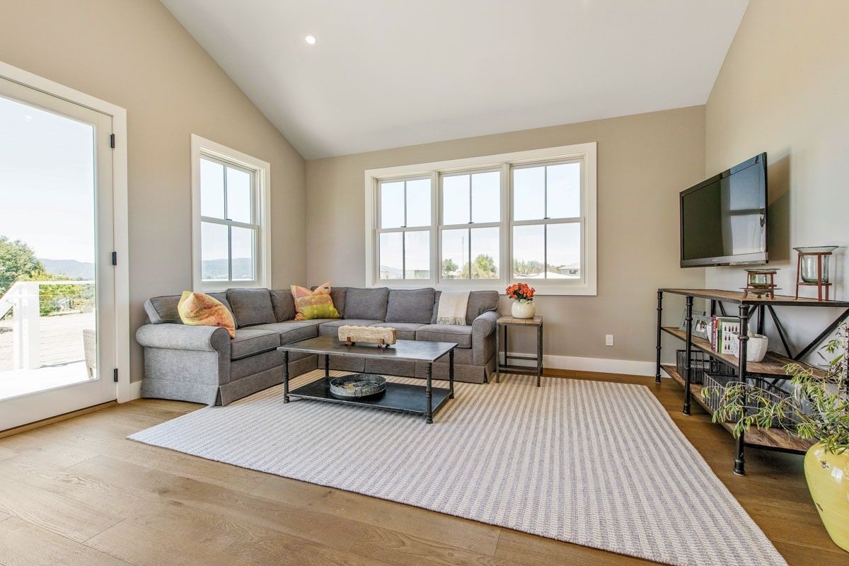 A living room with a couch , coffee table , and television.