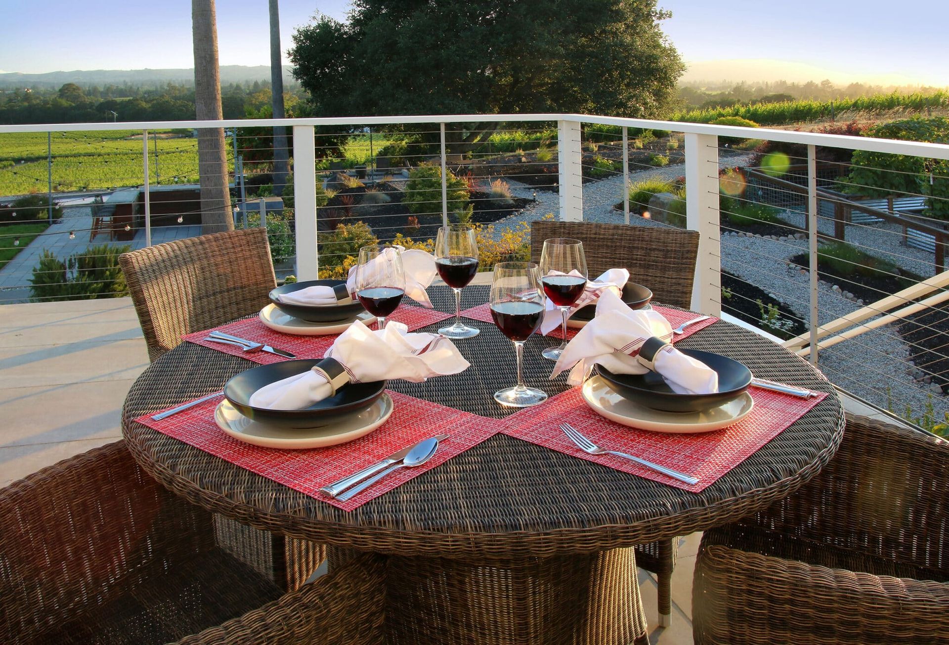 A table with plates and glasses of wine on it
