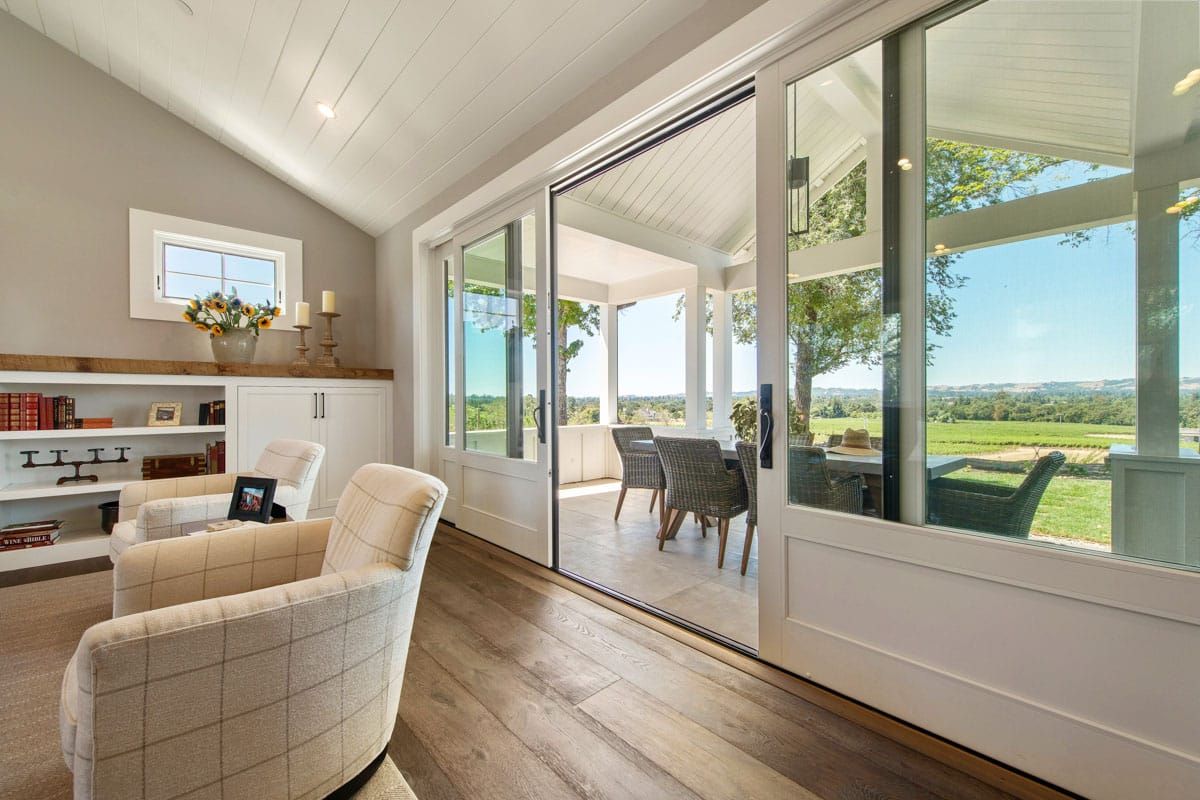 A living room with sliding glass doors leading to a patio.