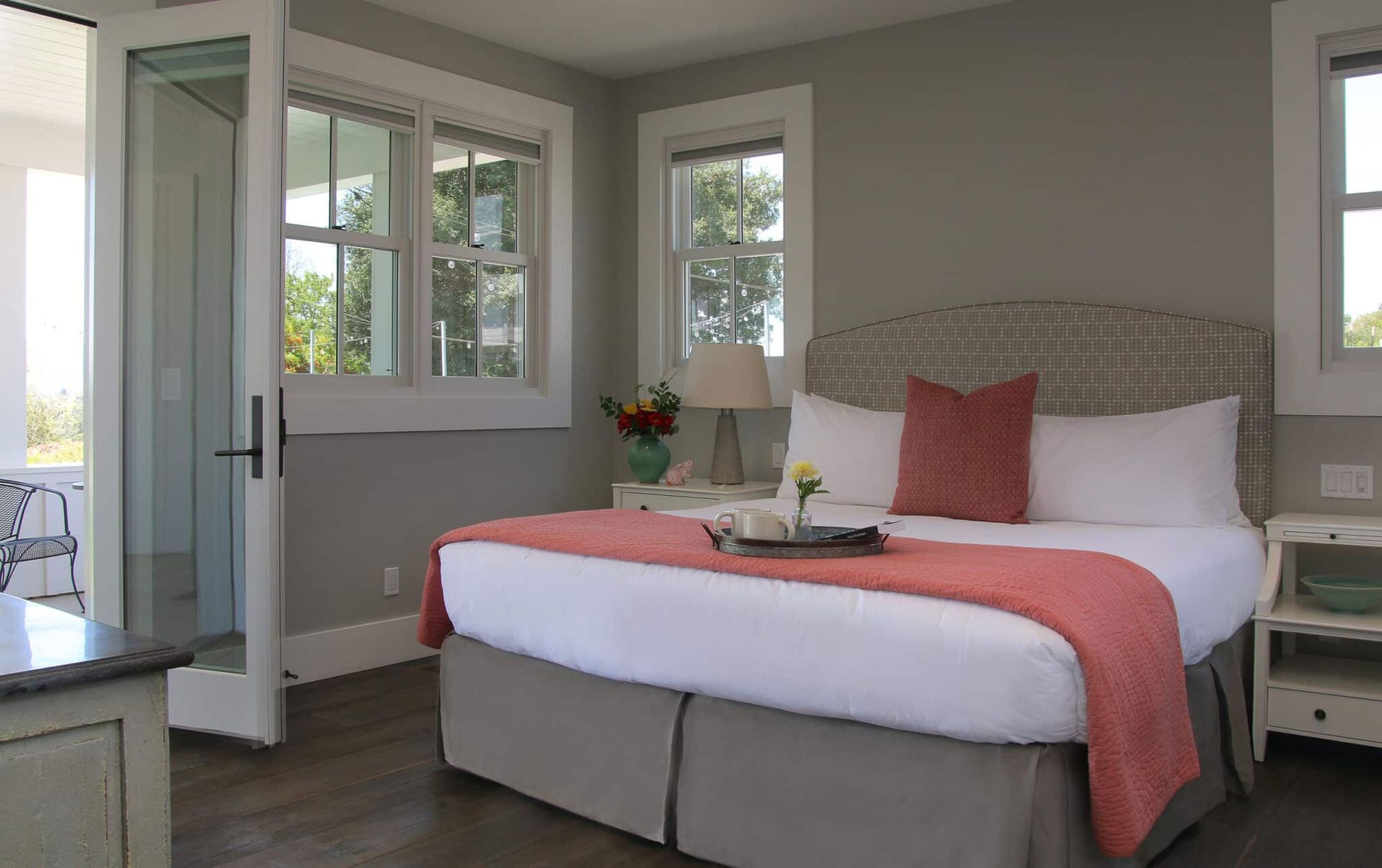 A bedroom with a king size bed and a tray on the bed.