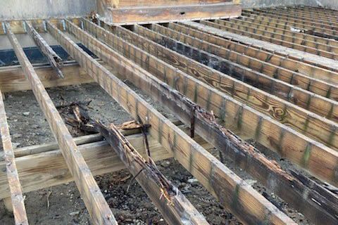 Badly damaged deck joists that will require a professional repairman in Denver metro