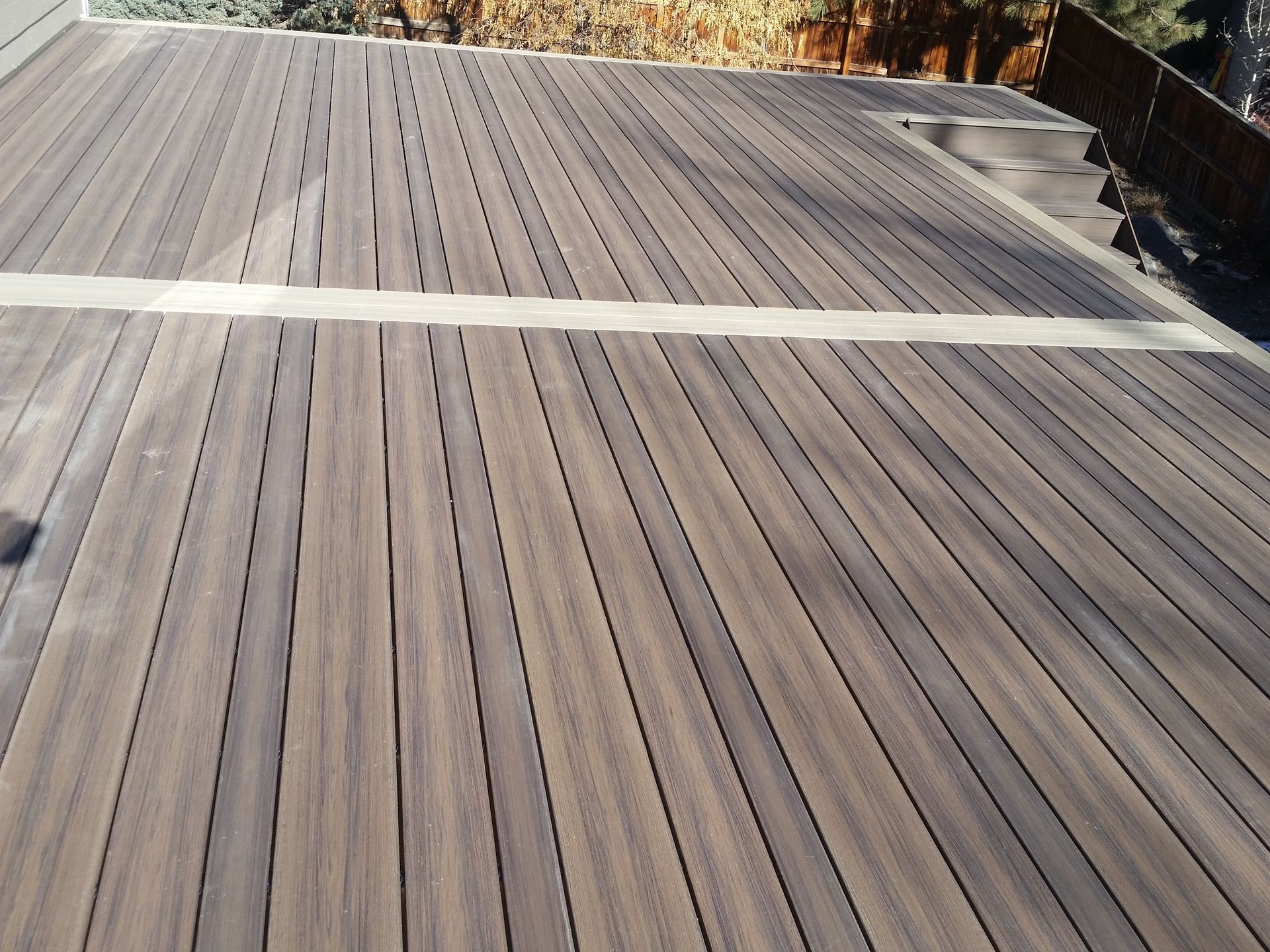 A wooden deck with a white line in the middle