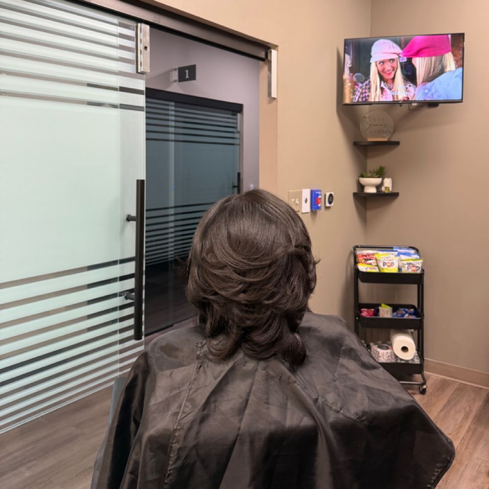 Smooth, voluminous round brush blowout at Pink Fin Beauty in Southfield, MI
