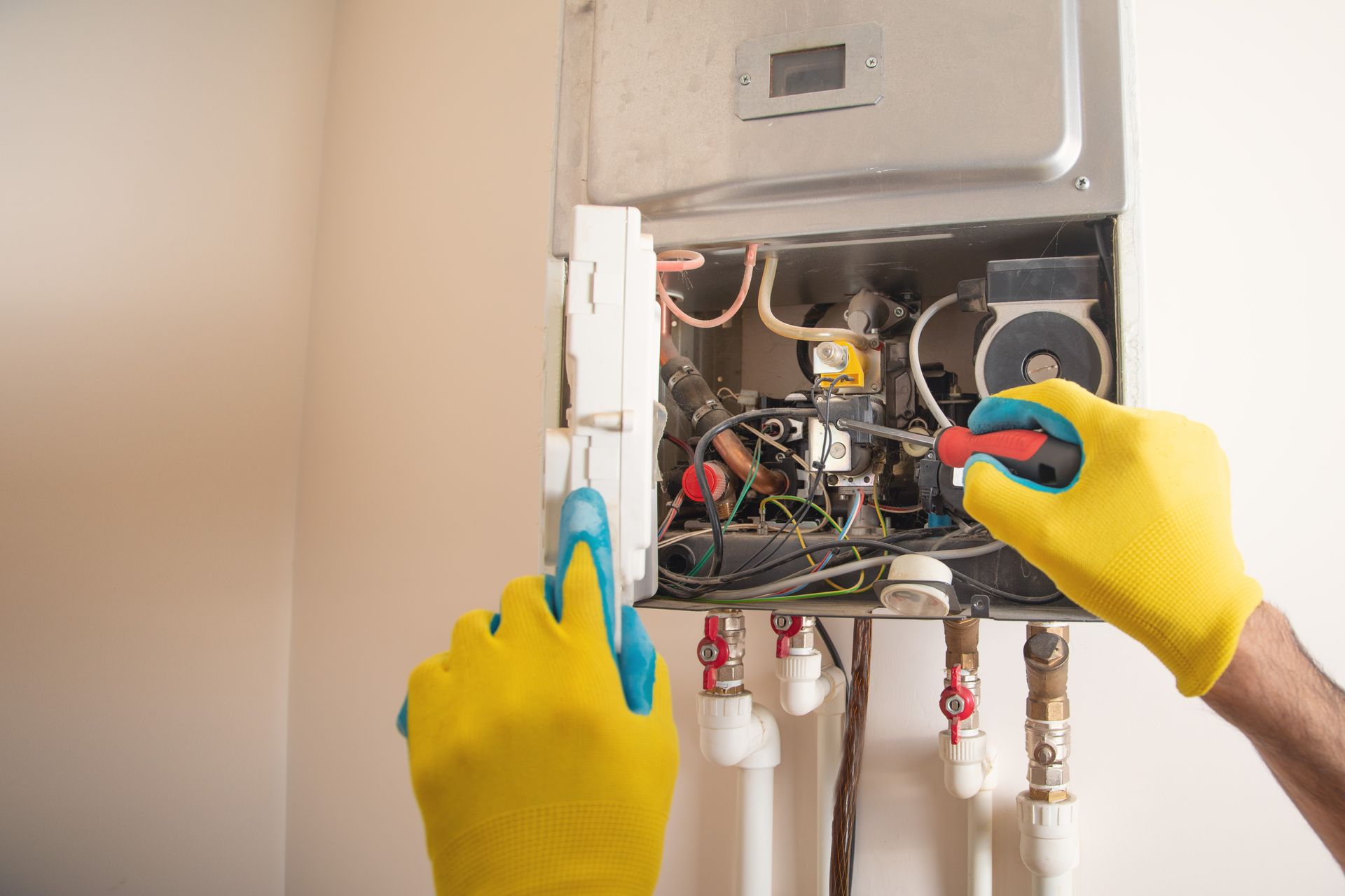 Furnace technician performing residential heating service in a home
