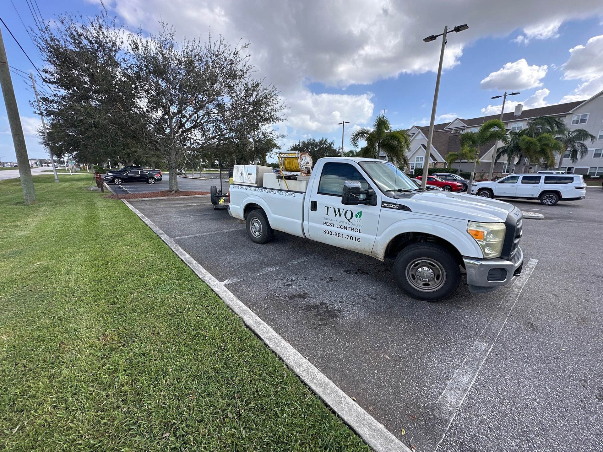 A white truck is parked in a parking lot.