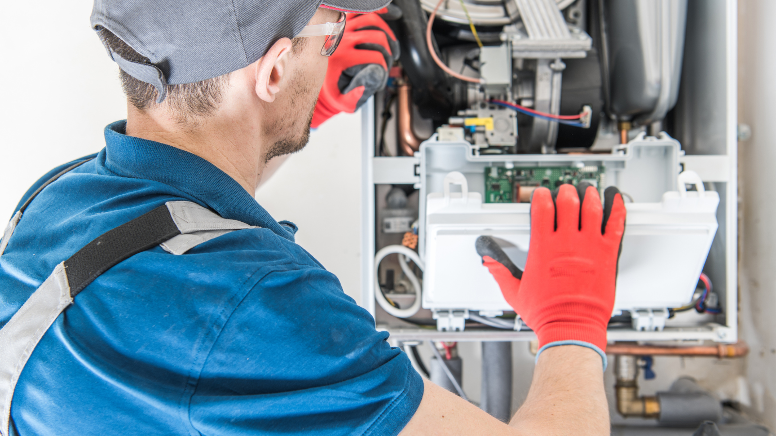 HVAC technician working on furnace