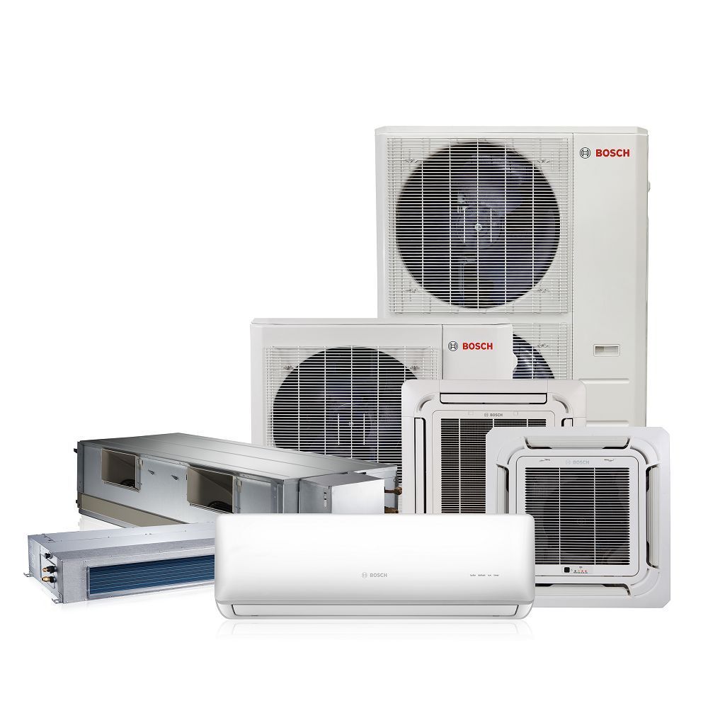 A group of air conditioners are sitting next to each other on a white background.