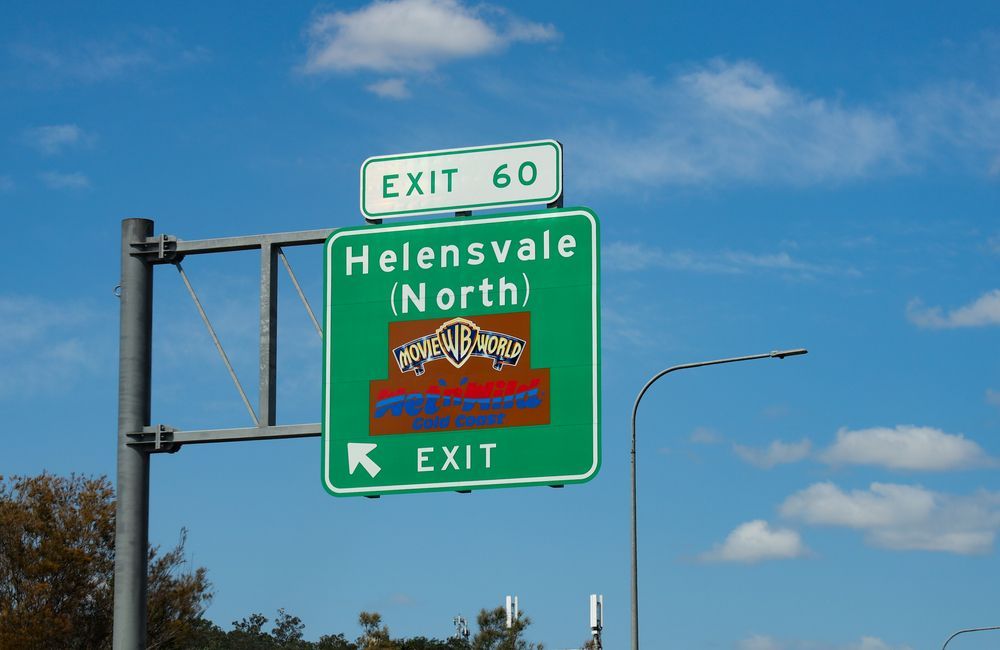 Green Highway Sign Exit 60, Helensvale, Arrow Indicating Exit Direction — Glenn Rowe Auto Electrics In Helensvale, QLD