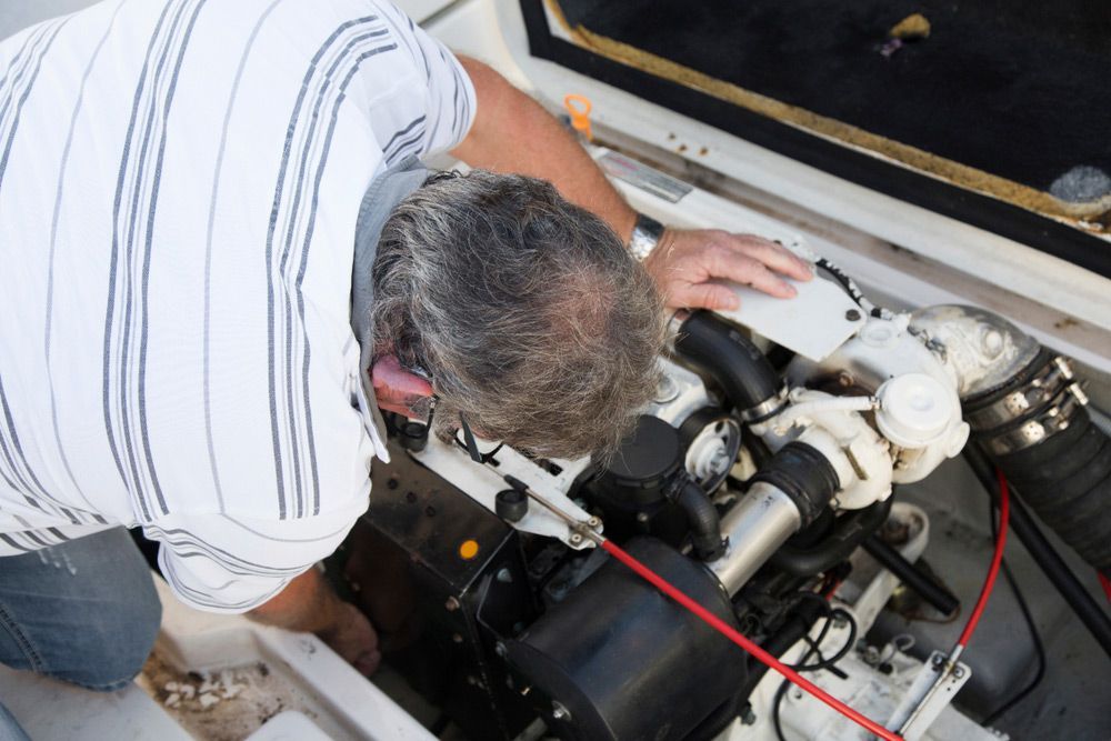 Close-Up Of A Man Repairing A Boat — Glenn Rowe Auto Electrics In Coolangatta, NSW