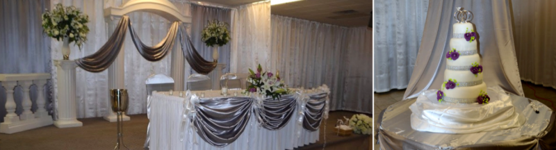 Decorated wedding reception hall with draped white and silver linens and a tiered white cake with lights