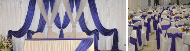 White and purple event hall with draped stage and rows of decorated banquet chairs