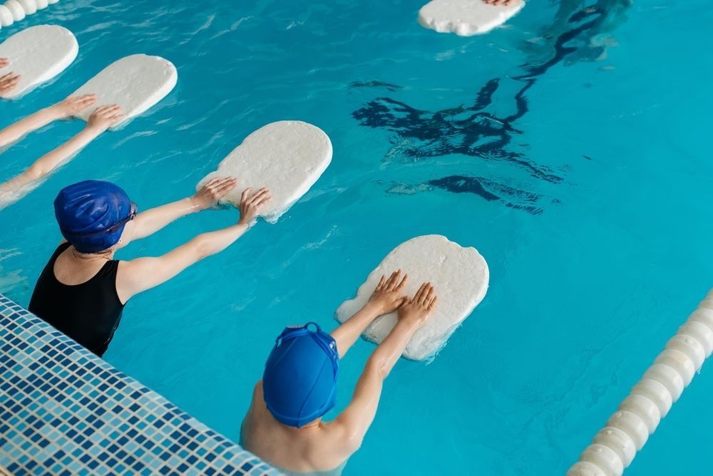 A Group of People Are Holding Floats in a Swimming Pool — North Wyong Aqua Centre In Wyong, NSW