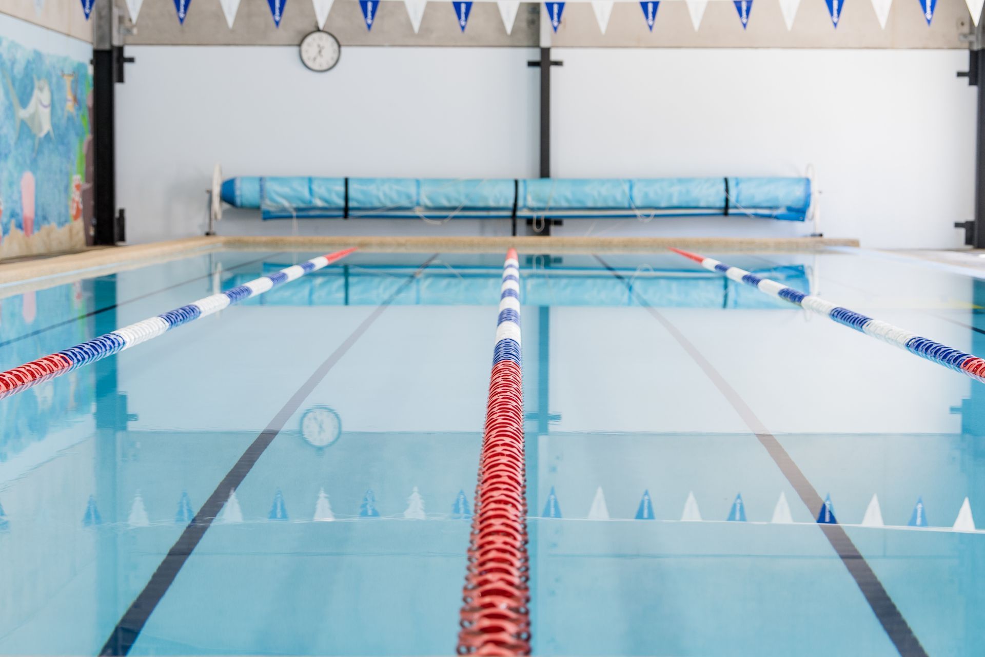 A Large Indoor Swimming Pool With a Clock on the Wall — North Wyong Aqua Centre In Wyong, NSW