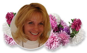 Smiling woman framed by white and pink flowers on a white background