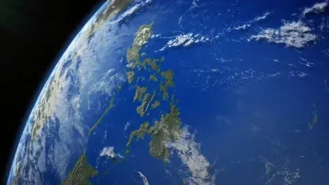 Earth viewed from space with blue oceans, white clouds, and the Philippine islands visible.