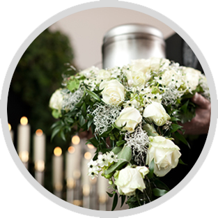 White rose bouquet with greenery and baby's breath in a wedding or memorial setting