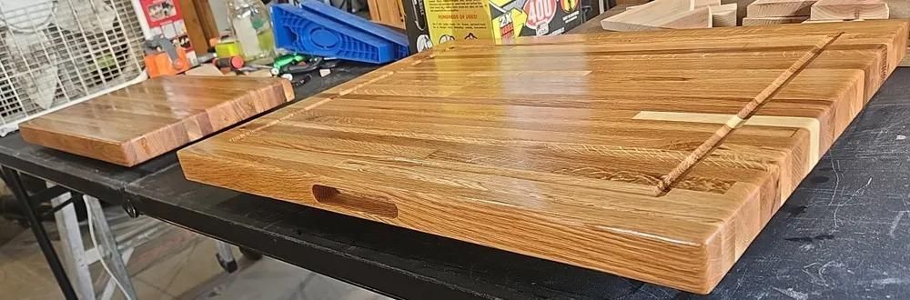 Wooden slatted bench or picnic table tops stacked in a workshop setting