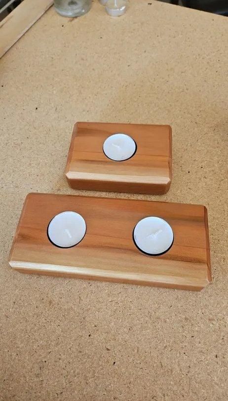 Two small wooden blocks with white circular magnets on a beige tabletop.