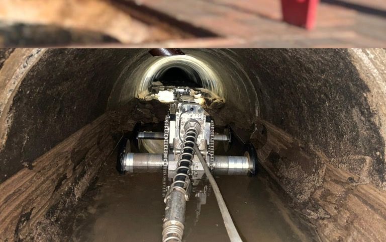 Tree root removal in sewer line