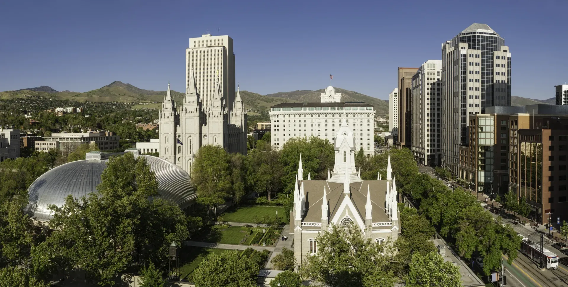 An aerial view of a city with a church in the middle