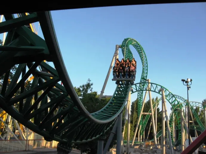 A roller coaster with a blue sky in the background