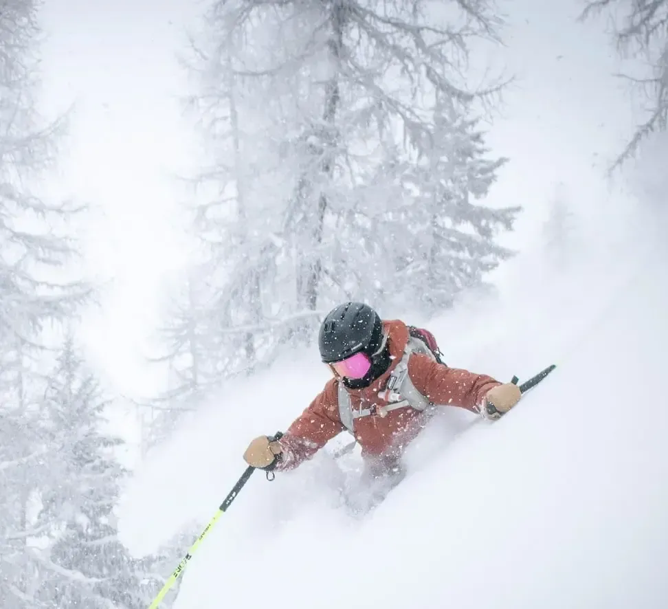A person is skiing down a snow covered slope.