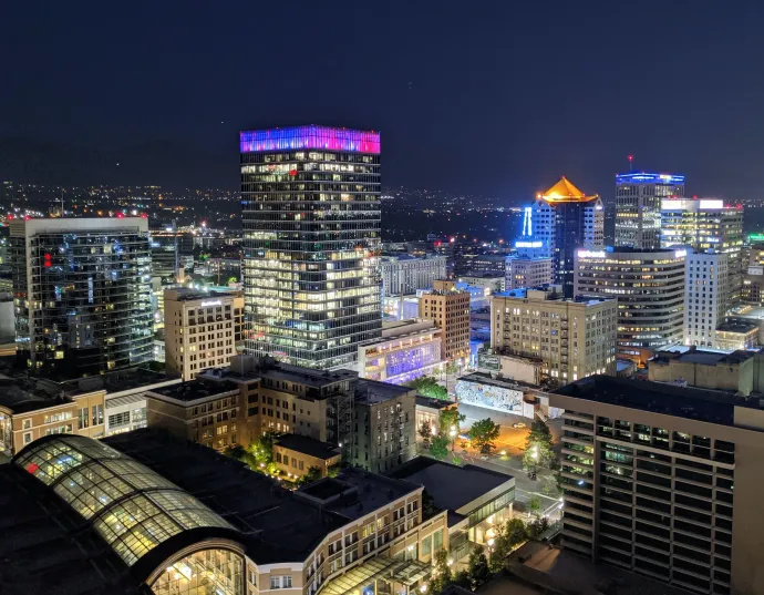 An aerial view of a city at night with lots of buildings lit up