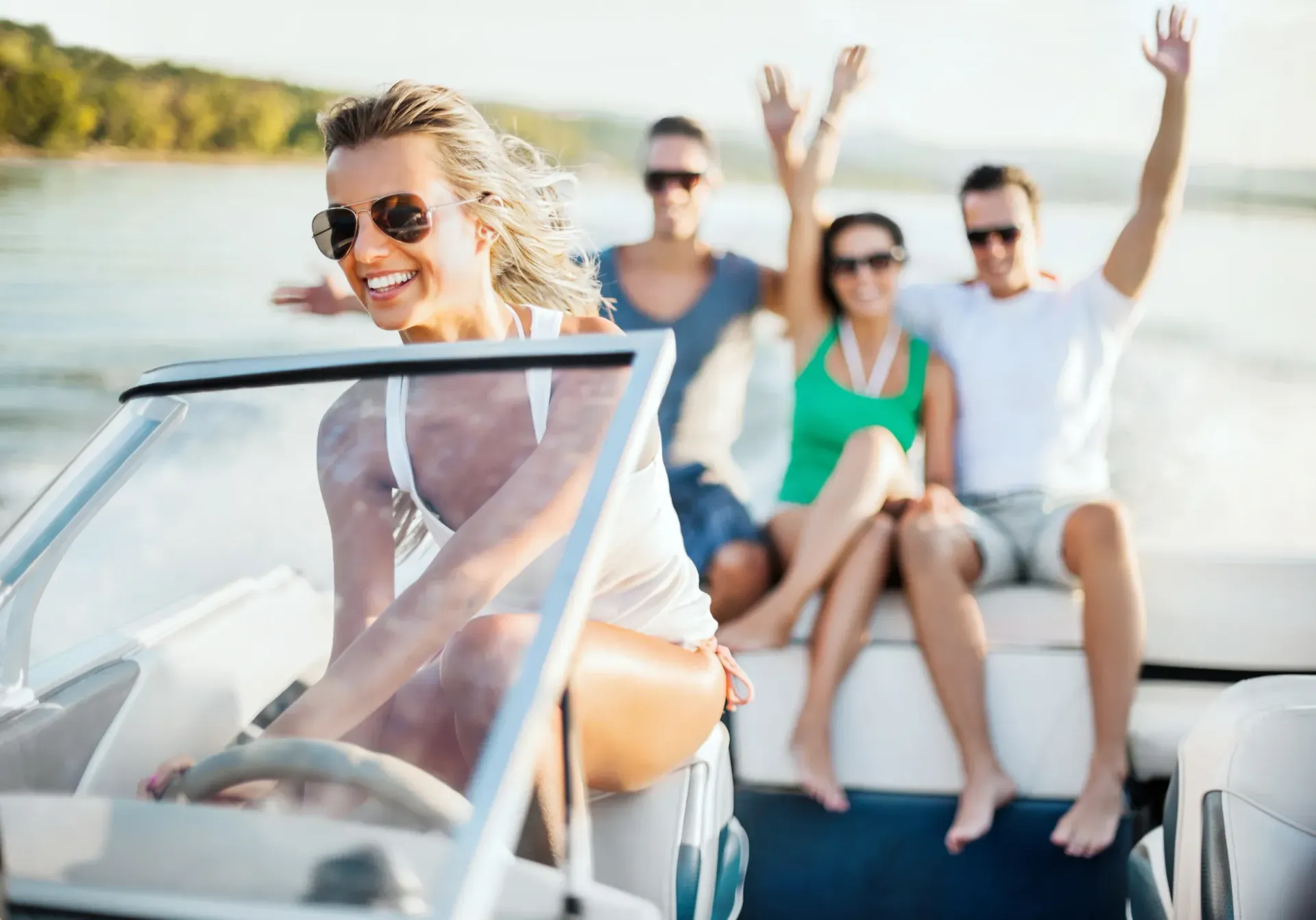 A group of people are riding a boat on a lake.