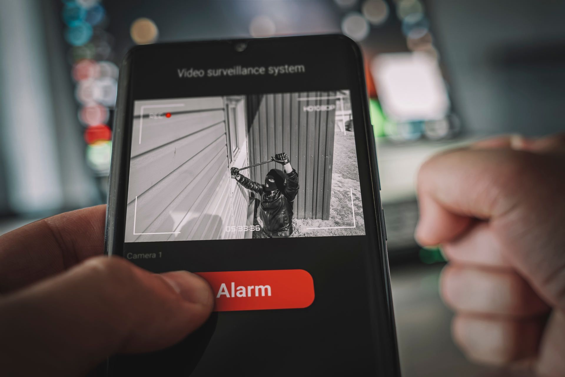 A person is holding a cell phone with a picture of a police officer on the screen.