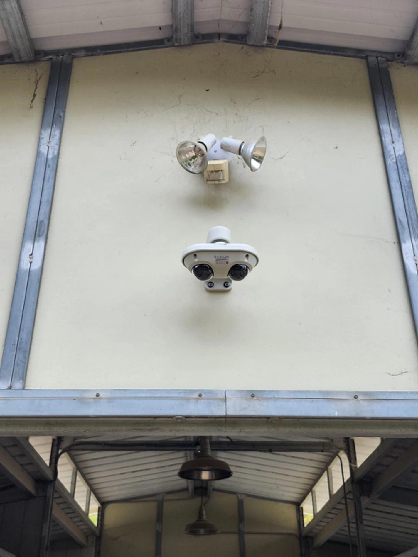 Two security cameras are mounted on the side of a building