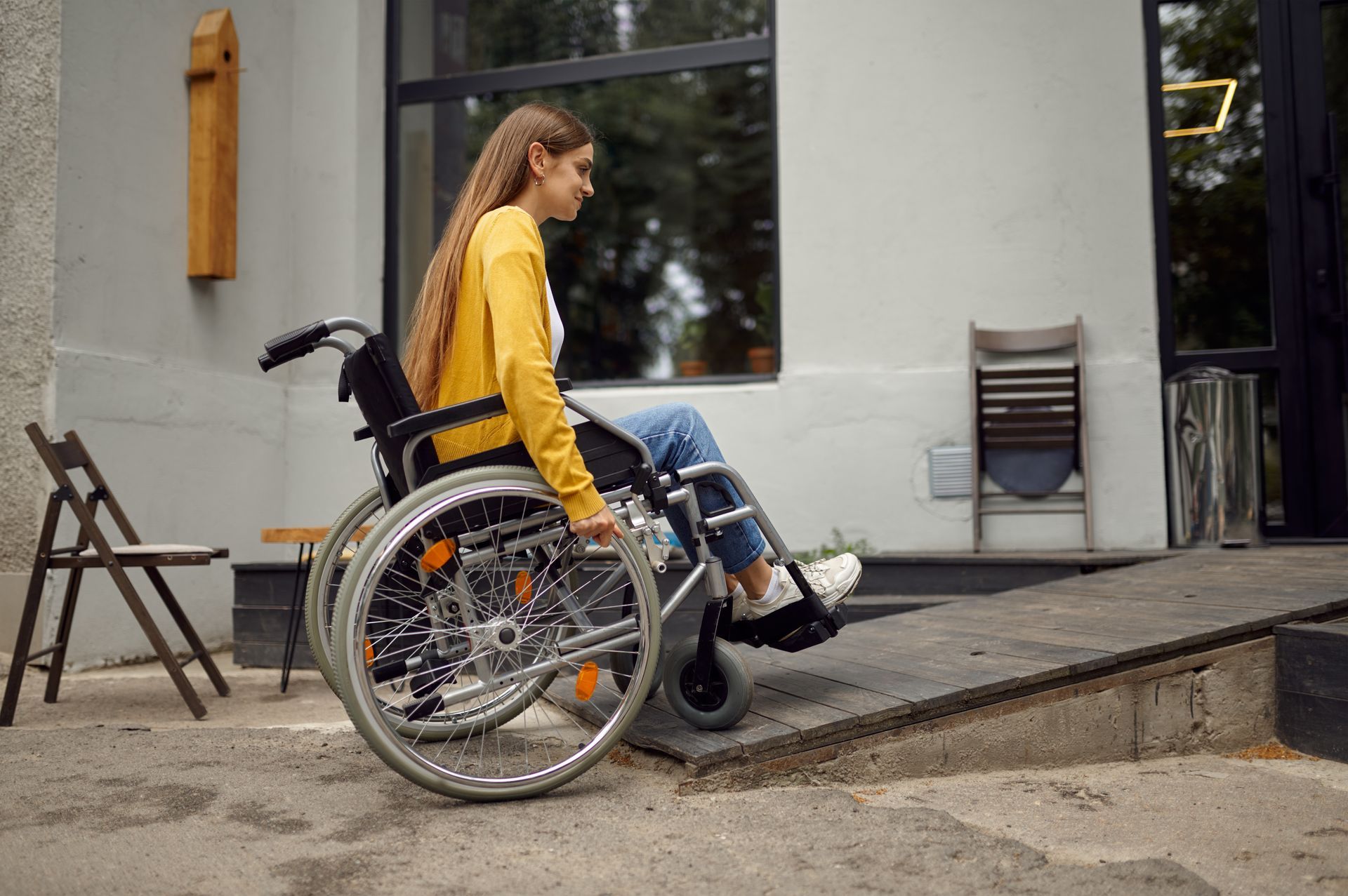a woman is sitting in a wheelchair in a living room .