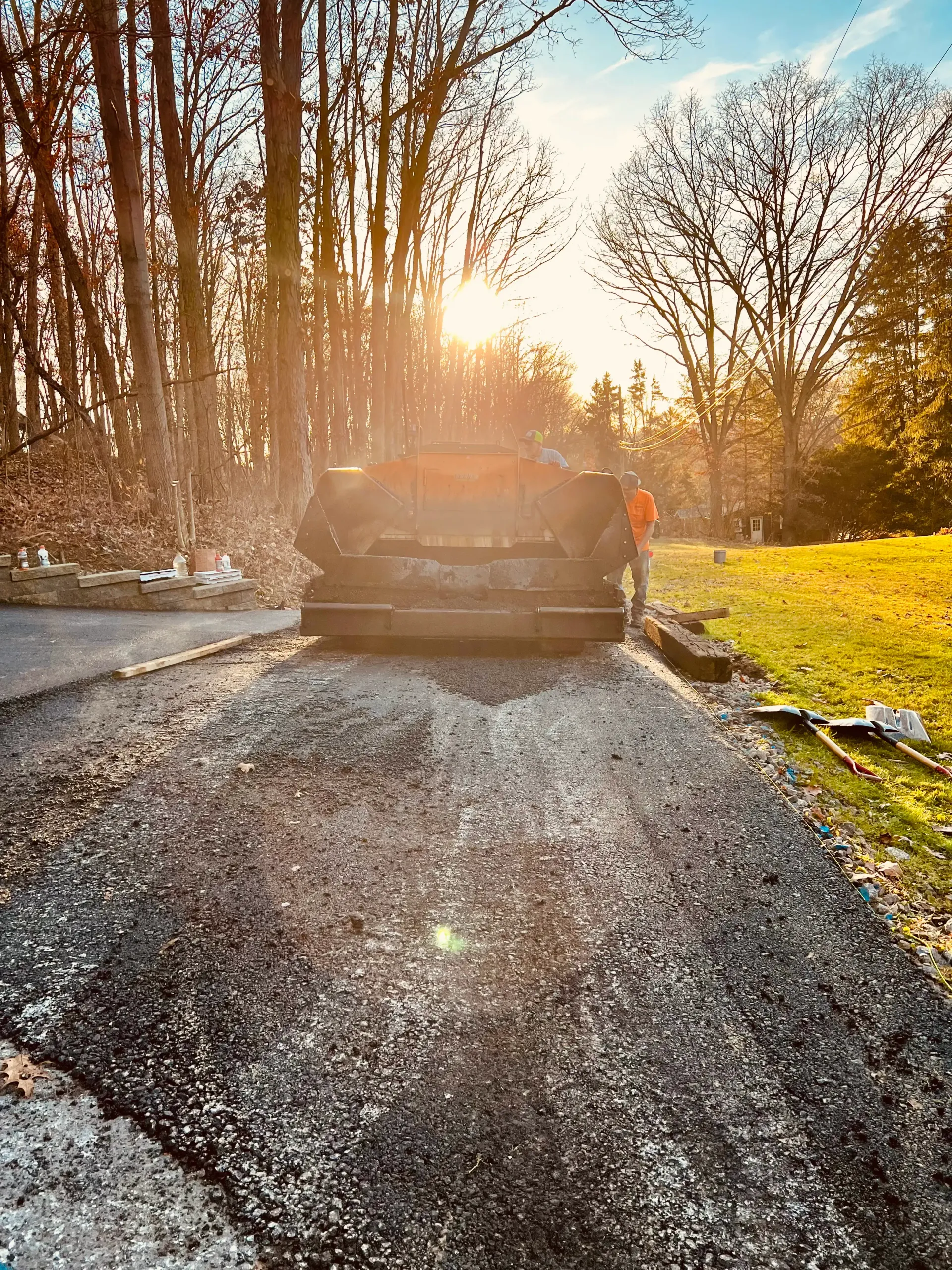 An asphalt paver paving a road